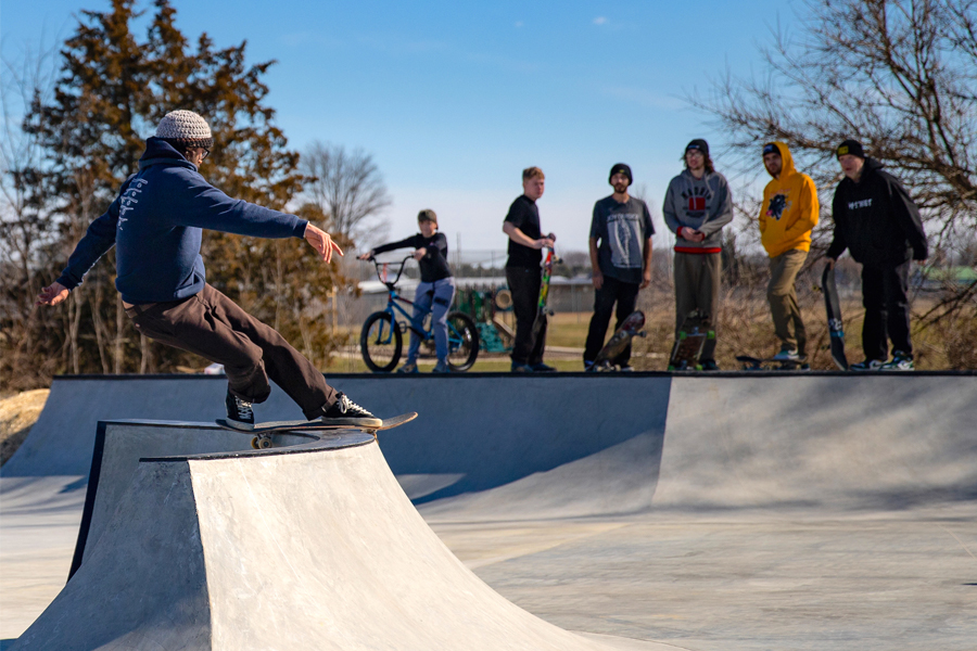 A person skates on a ramp.